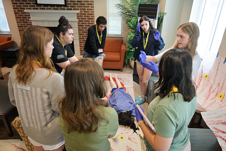 High school students work together to solve a mock crime scene June 5 during Middle Tennessee State University’s CSI:MTSU camp. Hosted June 3-6 by the Forensic Institute of Research and Education, campers learned about careers in forensic science through lectures and demonstrations, culminating in a mock crime scene investigation on campus in Murfreesboro, Tenn. (MTSU photo by Andy Heidt)