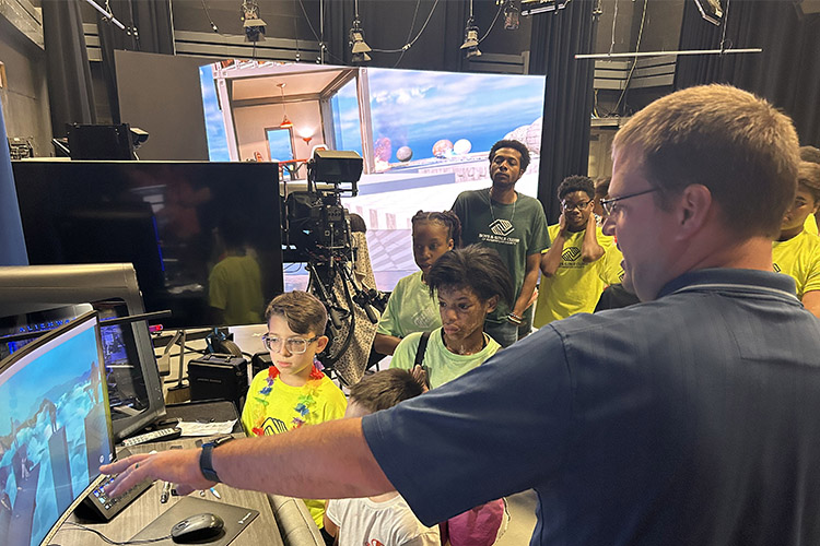 Mike Forbes, right, director of technical systems for the Department of Media Arts at Middle Tennessee State University, gives students from the Boys and Girls Clubs of Rutherford County a tour of the XR Studio in the Bragg Media and Entertainment Building during the recent “Come to Voice” digital literacy summer camp sponsored by the College of Media and Entertainment. The camp brought 20 seventh through ninth graders to MTSU to learn about digital media and other career paths offered at the university in Murfreesboro, Tenn. (MTSU submitted photo)