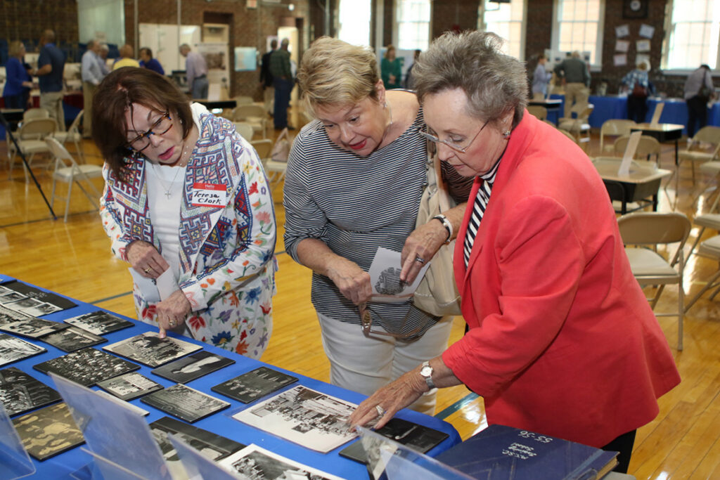 Teresa J. Clark-Owens, left, Marylou Turpin and Linda Dansby look at historical photos related to the Homer Pittard Campus School during its 90th anniversary celebration Tuesday, April 16, at the school’s East Lytle Street campus. The teaching laboratory school is owned by MTSU and operated by Rutherford County Schools. (MTSU photo by James Cessna)
