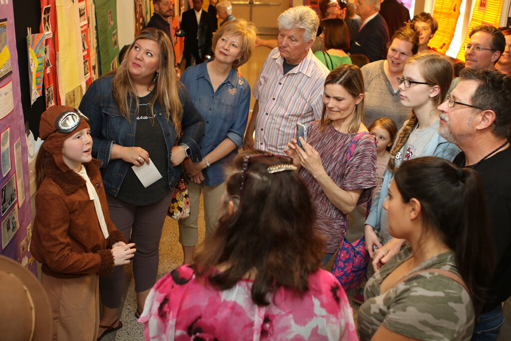 Campus School fifth-grader Emma Griffith, far left, is surrounded by visitors as she portrays historical figure and famed pilot Amelia Earhart as part of Homer Pittard Campus School’s open house. The teaching laboratory school owned by MTSU and operated by Rutherford County Schools held its 90th anniversary celebration Tuesday, April 16, at the school’s East Lytle Street campus. (MTSU photo by James Cessna)