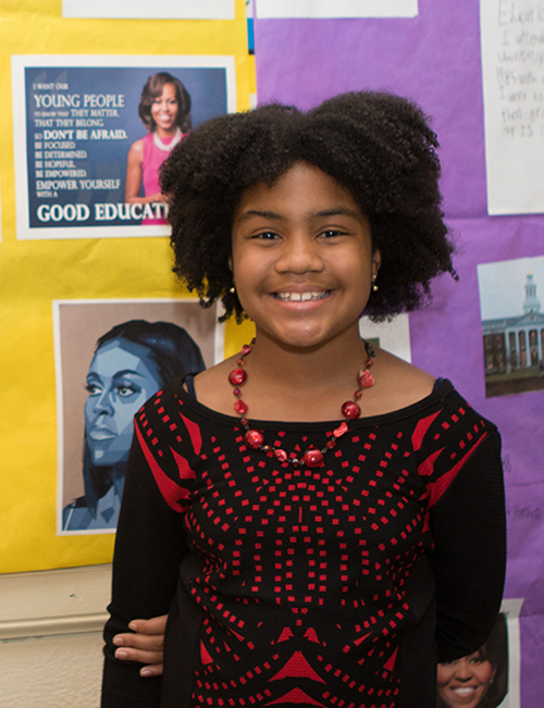 Campus School fifth-grader Jada Scott, portraying former first lady Michelle Obama, stands in front of the display that was part of Homer Pittard Campus School’s open house. The teaching laboratory school owned by MTSU and operated by Rutherford County Schools held its 90th anniversary celebration Tuesday, April 16, at the school’s East Lytle Street campus. (MTSU photo by James Cessna)