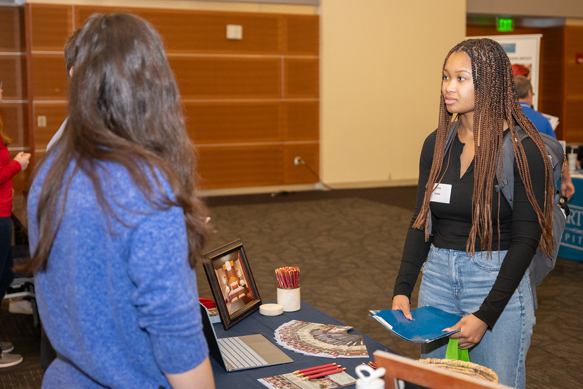Middle Tennessee State University student Emma Samba of Knoxville, Tenn., talks with recruiters at the Tourism and Hospitality Management and Leisure and Sport Management Spring Career Fair on Feb. 26 in the Student Union Ballroom. Samba, a tourism major, plans to use her degree to find a job that allows her to travel, and she eventually plans to start her own business. (MTSU photo by James Cessna)