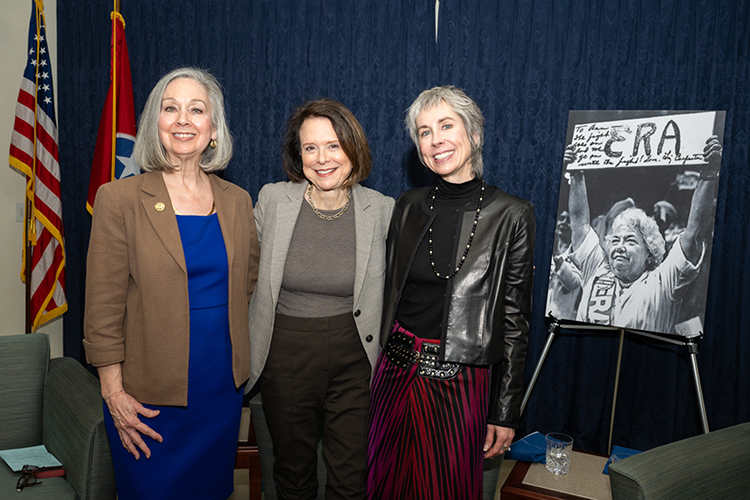 From left, Middle Tennessee State University history professor Mary Evins, documentary filmmaker Christy Carpenter and Nashville PBS executive Sarah Childress pose for a photo at the public talk held March 19 inside the Paul W. Martin Sr. Honors Building on the MTSU campus in Murfreesboro, Tenn. Held as part of the university’s National Women’s History Month activities, Carpenter was interviewed about “Shaking It Up! The Life and Times of Liz Carpenter,” a film about Carpenter’s mother, trailblazing journalist and feminist whose photo is displayed at right. (MTSU photo by James Cessna)