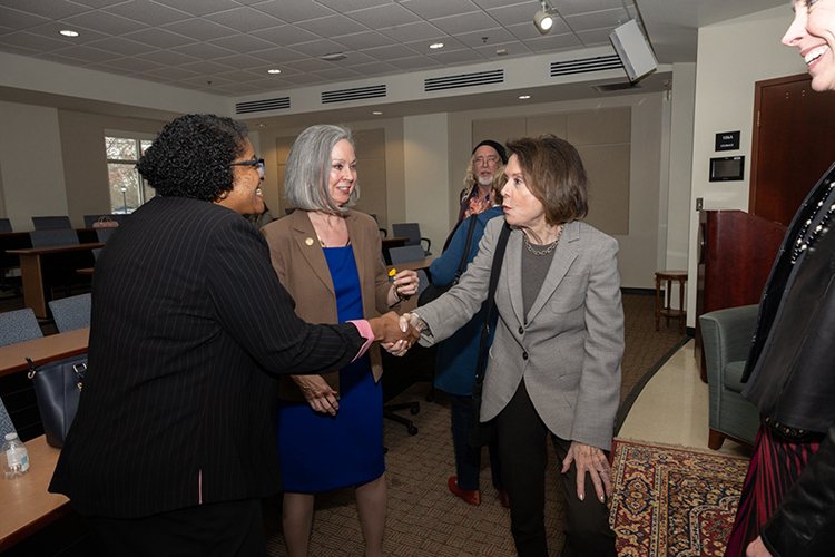 Middle Tennessee State University College of Liberal Arts Dean Leah Lyons, left, greets documentary filmmaker Christy Carpenter, right, who was interviewed about the film she co-directed titled “Shaking It Up! The Life and Times of Liz Carpenter,” a film about Carpenter’s mother, trailblazing journalist and feminist on March 19 inside the Paul W. Martin Sr. Honors Building on campus in Murfreesboro, Tenn. History professor Mary Evins, center, moderated the discussion, held as part of the university’s National Women’s History Month activities. (MTSU photo by James Cessna)