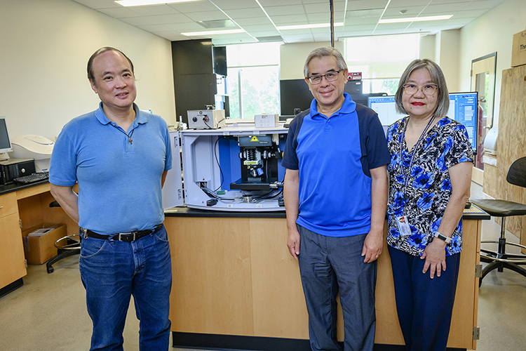 Middle Tennessee State University chemistry faculty, from left, Charles Chusuei, Sing Chong and Beng Guat Ooi are shown Thursday, Aug. 18, at the Science Building on campus in front of a specialized Raman confocal microscope, one of the department’s four recently acquired, cutting-edge pieces of chemistry instrumentation that they hope will expand research and hands-on experience opportunities for faculty and students. (MTSU photo by J. Intintoli)