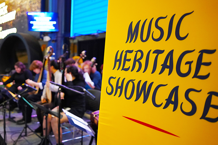 A sign in the Bridgestone Arena concourse highlights the Music Heritage Showcase, as members of the Chinese Music Ensemble at Middle Tennessee State University in Murfreesboro, Tenn., play on stage at the Nashville Predators hockey game for their Asian and Pacific Islander music heritage night on Dec. 9. The performance gave students a rare opportunity to present traditional Chinese music to a stadium audience. (MTSU photo by Mike Davis)