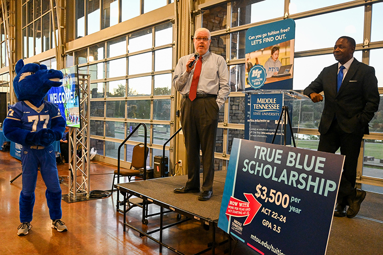Greg Smith, Middle Tennessee State University alumnus, speaks to the crowd of prospective students and their families at the MTSU True Blue Tour event on Wednesday, Sept. 28, 2022, about his pride in his True Blue education at the Wilma Rudolph Event Center in Clarksville, Tennessee. At right is MTSU President Sidney A. McPhee. (MTSU photo by Stephanie Wagner)