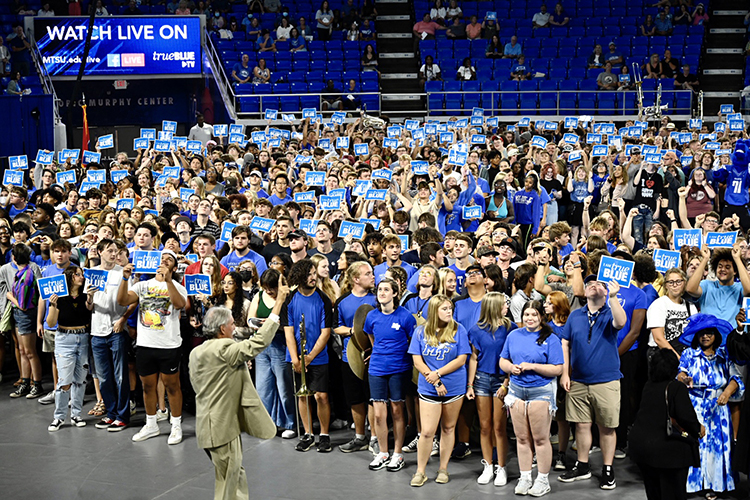New freshmen and transfer students pose for a group photo showing their True Blue spirit on the floor of Murphy Center following the 2022 University Convocation Aug. 21.