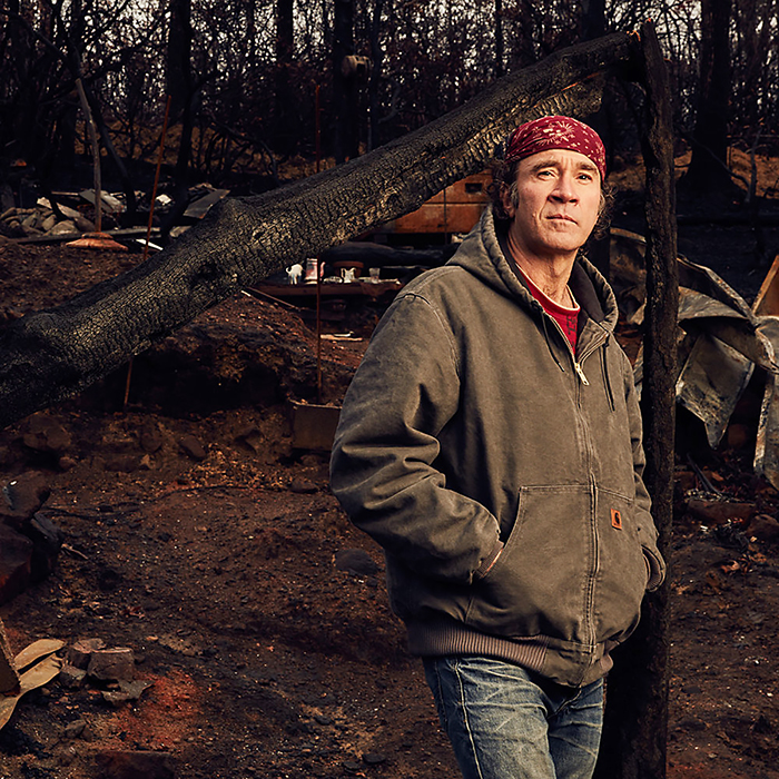 Kirk Fleta pauses in the ashen ruins of his home, destroyed in the deadly 2016 wildfires that swept through portions of the Great Smoky Mountains, devastating Gatlinburg, Pigeon Forge and more than 10,000 acres of the national park in this photo captured by MTSU alumnus and photographer/entrepreneur Jeremy Cowart for his "Voices of Gatlinburg" project. Cowart's work will be on exhibit at MTSU's Baldwin Photographic Gallery Nov. 25-Jan. 31. (Photo by Jeremy Cowart)