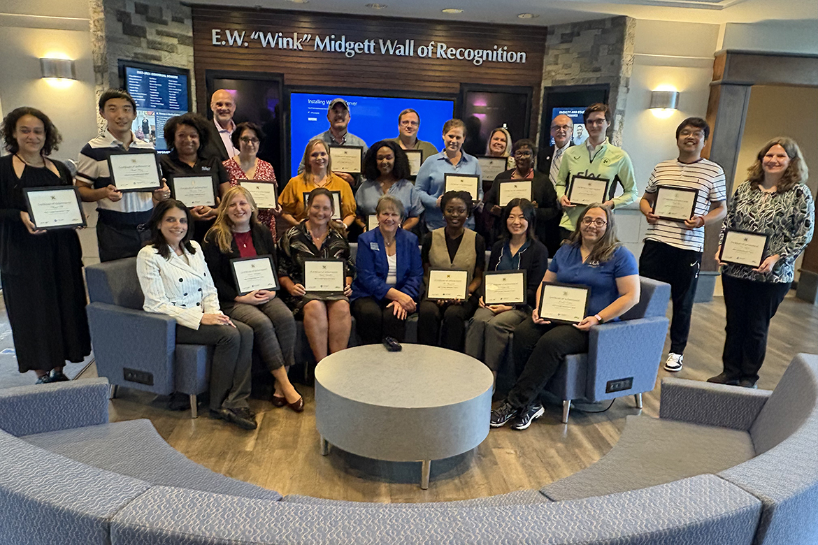 Joyce Heames, seated center, dean of the Jones College of Business at Middle Tennessee in Murfreesboro, Tenn., joins the 20 faculty and staff participants who completed the three-day Dale Carnegie summer immersion course held in early August, along with a few instructors, for a group photo inside the Business and Aerospace Building on campus in Murfreesboro, Tenn. (MTSU photo by Darby Campbell-Firkus)