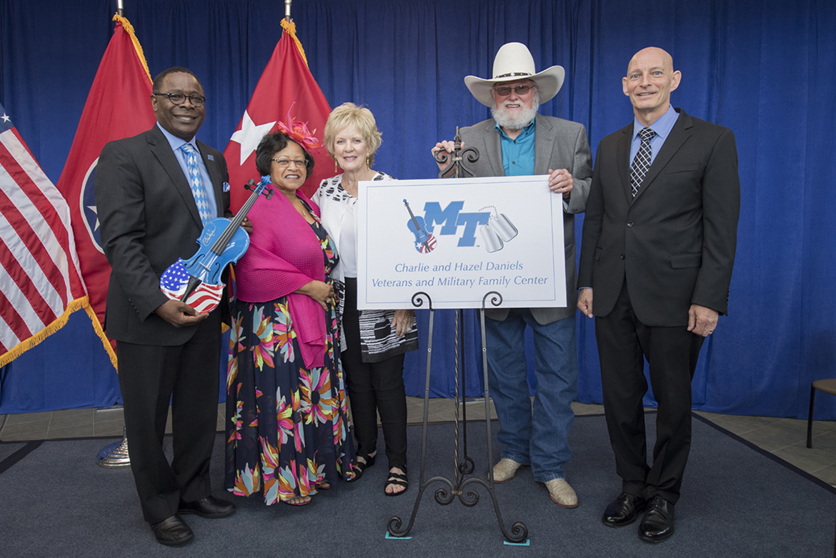 MTSU President Sidney A. McPhee, left, first lady Elizabeth McPhee, Hazel Daniels, Charlie Daniels and Keith M. Huber, senior adviser for veterans and leadership initiatives, display the new Charlie and Hazel Daniels Veterans and Military Family Center logo unveiled in an Aug. 23 celebration. The event recognized the couple and The Journey Home Project for gifts totaling $120,000 for the center. Daniels, who died Monday, July 6, autographed the patriotic fiddle McPhee is holding and presented it to the center as a gift from him and the foundation. (MTSU file photo by Andy Heidt)