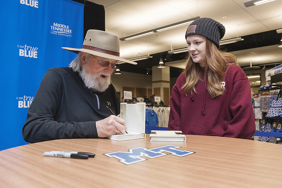 Country Music Hall of Fame member Charlie Daniels, left, signs copies of his new inspirational book, “Let’s All Make the Day Count: The Everyday Wisdom of Charlie Daniels,” for MTSU junior animal science major Kaylin Kirk, 21, of Fort Myers, Fla., in November 2018 at MTSU’s Phillips Bookstore. Daniels, 83, died Monday, July, 6. (MTSU file photo by Andy Heidt)