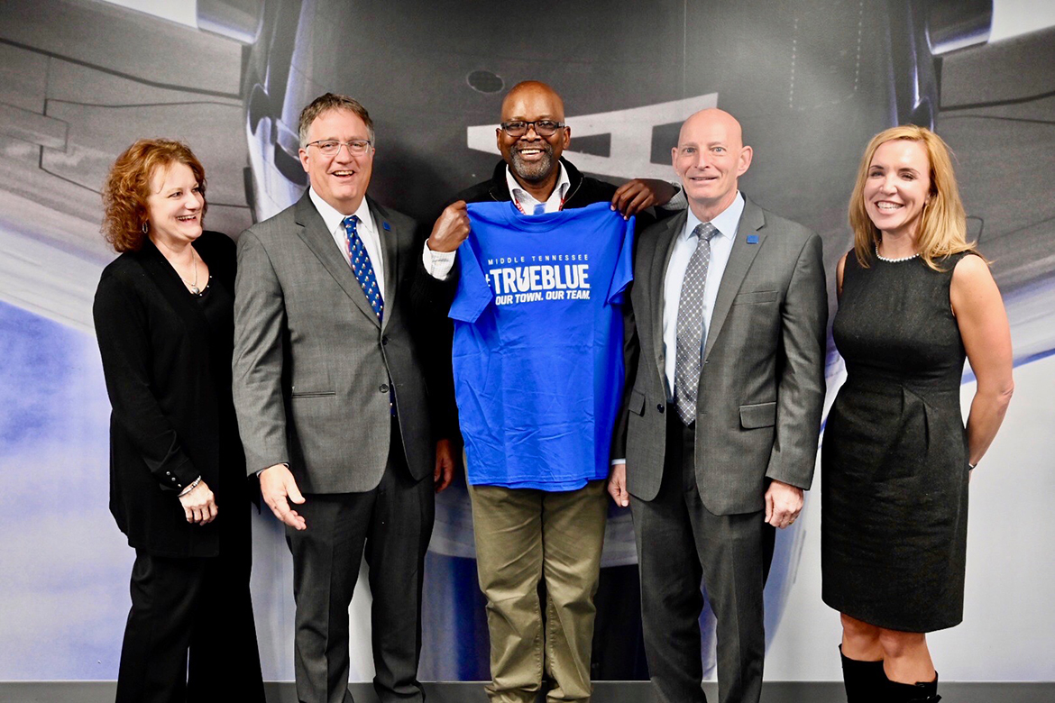 MTSU Provost Mark Byrnes, second from left, welcomes Army veteran Tyrone Barmore, center, a Delta supply attendant and secretary of its veteran group, as an MTSU student. Barmore will enroll at the university in January through MTSU’s Adult Degree Completion Program. Joining Byrnes was retired Army Lt. Gen. Keith Huber, MTSU’s senior advisor for veterans and leadership initiatives, second from right; Peggy Carpenter, associate dean of University College, far left; and Hilary Miller, director of MTSU’s Charlie and Hazel Daniels Veterans and Military Family Center, far right. (MTSU photo by Andrew Oppmann)