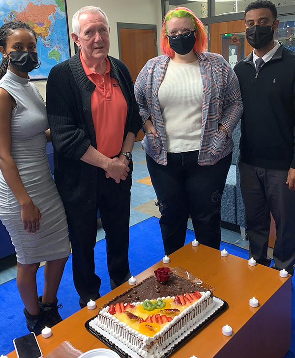 Dwight Johnson, second from left, celebrates 27 years as proprietor of Dwight's Mini Mart at Oct. 25 festivities in his honor in MTSU's Intercultural and Diversity Affairs office. Johnson, who is blind, received a plaque to mark the occasion as part of National Disability Employment Awareness Month. Others, from left, are Mahlet Akilile, IDA program assistant; Miranda Johnson, Dwight Johnson's daughter; and Daniel Green, IDA director. (MTSU photo by Daniel Green)