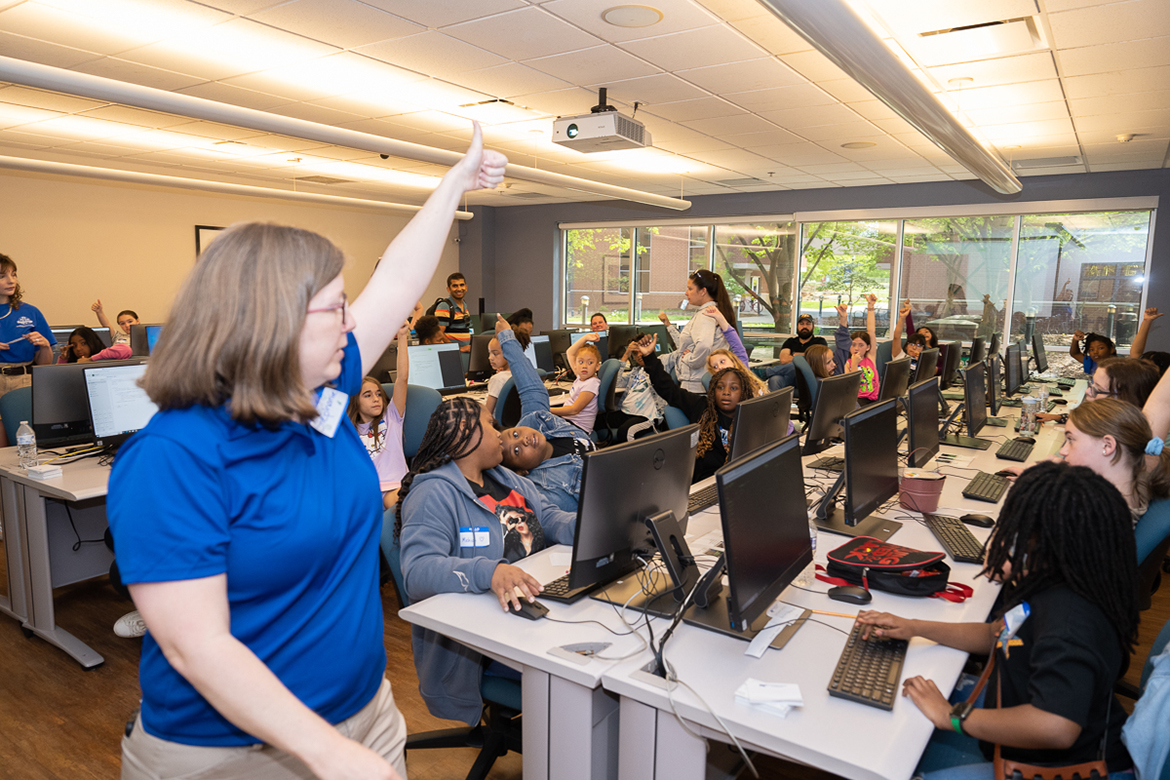 Middle Tennessee State University information systems and analytics assistant professor Stephanie Totty gives instructions to a roomful of young girls attending the "Code Like a Girl" camp on April 15 at the Business and Aerospace Building. Almost 30 young girls attended the free camp hosted by Django Girls Murfreesboro in partnership with the MTSU Department of Information Systems and Analytics and the MTSU student chapter of the Association of Information Systems. (MTSU photo by James Cessna)