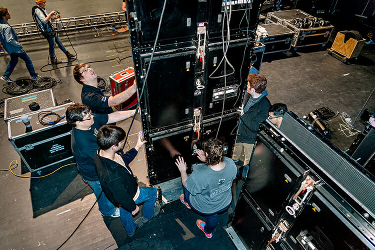 Mike Forbes, shown at center left looking up, works with students to install LED panels on the Tucker Theatre stage for the set of "Joseph and the Amazing Technicolor Dreamcoat" in this March 2018 file photo. Forbes, assistant director of technical systems for MTSU's Department of Media Arts, volunteered for Moderna Inc.'s coronavirus vaccine clinical trials in Nashville this summer, caught COVID-19 in the fall and is healthy again and encouraging others to be immunized as soon as the vaccine is available. (MTSU file photo by J. Intintoli)