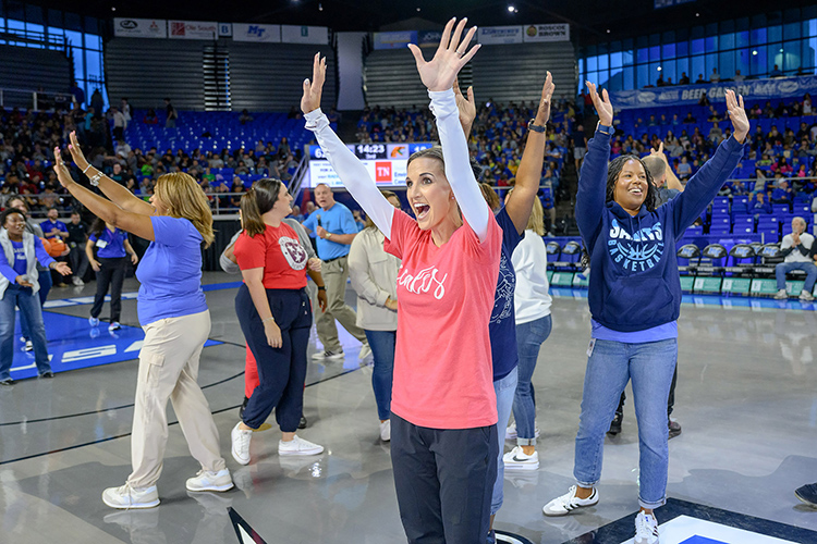 Murfreesboro City Schools administrators participating in a shooting contest enjoy a moment in the spotlight Nov. 9, 2023, during the 10th annual Education Day game between the Middle Tennessee State University women’s basketball team and the Florida A&M Rattlers inside Murphy Center. The game brings thousands of MCS fourth through sixth graders to campus. (MTSU photo by J. Intintoli)