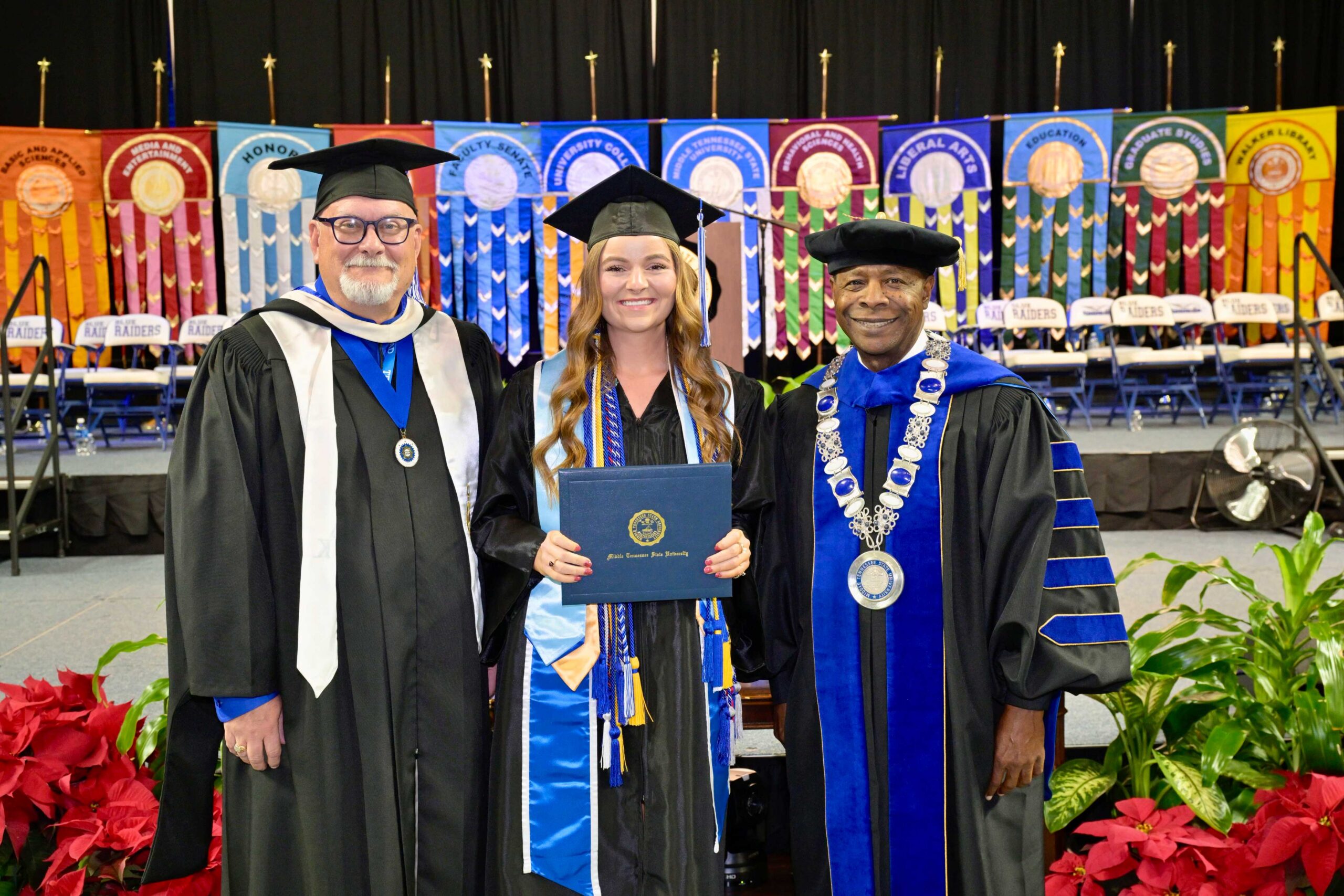 Ella Cobb pictured here in the center with Vice President of Marketing and Communications Division Andrew Oppmann (left) and MTSU President Sidney A. McPhee (right) after the second December 2024 commencement ceremony. (Photo: Andy Heidt)