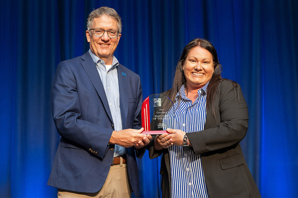Middle Tennessee State University Provost Mark Byrnes presents the 2024-25 Classified Employee of the Year Award to Kristen Rabinowitz from Enrollment Technical Services at a ceremony held Thursday, April 24, at James Union Building on campus in Murfreesboro, Tenn. She was one of four employees to receive an award. (MTSU photo by Andy Heidt)