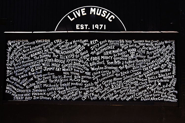 This mural, which is on the wall outside the Exit/In, lists the names of some of the famous acts that have played the venue on Elliston Place in Nashville. They represent a variety of genres, including rock, folk, country, and blues. (Photo by Ryan Green from Exit/In website)