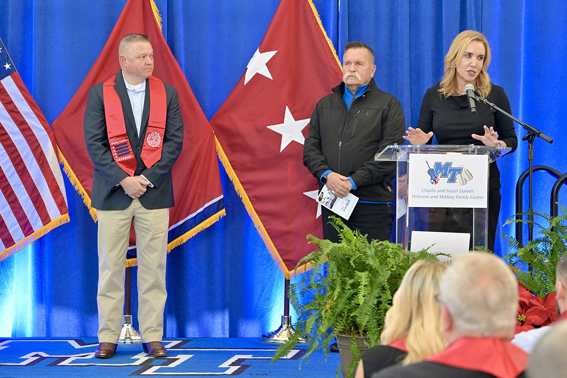 Hilary Miller, director of the Charlie and Hazel Daniels Veterans and Military Family Center at MTSU, and David Corlew, Journey Home Project cofounder with Daniels, present the Daniels Center Journey Award to Gary George at the Graduating Veterans Stole Ceremony held Thursday, Dec. 14, in Miller Education Center on the Middle Tennessee State University campus. (MTSU photo by Andy Heidt)