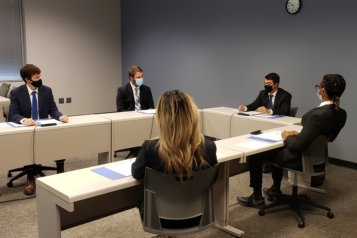 Members of MTSU’s National College Fed Challenge team recently film their video presentation Oct. 5, 2020, inside the Business and Aerospace Building. The presentation, in which the student team made policy recommendations about the current economy, was submitted to representatives with the Federal Reserve for judging. Pictured clockwise, from far left, are seniors Aaron Stagner, a history major with an economics minor from Altoona, Iowa; Kyle Chandler, an economics major from Murfreesboro, Tenn.; Kannan Akins, an economics major from Lebanon, Tenn.; Joshua Smith, an economics major from Nashville, Tenn.; and Emma Praskach, an economics major from upstate New York. Not pictured is alternate Garrett Thurman, an economics major from McMinnville, Tenn. (MTSU photo by Jimmy Hart)