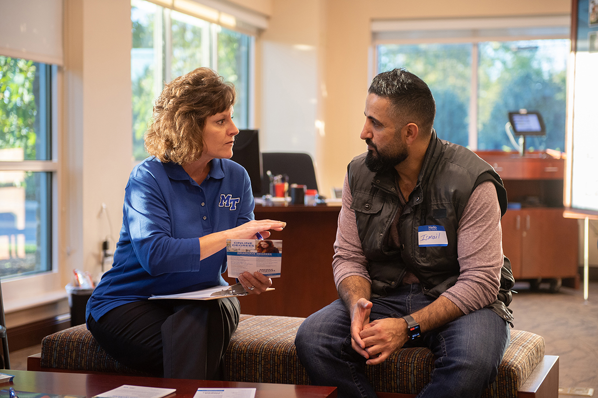 In this file photo, Dr. Dianna Rust, left, professor and program coordinator for integrated and professional studies in MTSU’s University College, talks to a prospective student at a “Finish Your Degree” Q&A event held at Rutherford County Chamber of Commerce in Murfreesboro, Tenn. MTSU is hosting another event 4 to 7 p.m. July 19 in Smyrna in the Mary Lou Apple Building at Motlow State Community College. (MTSU file photo by James Cessna)