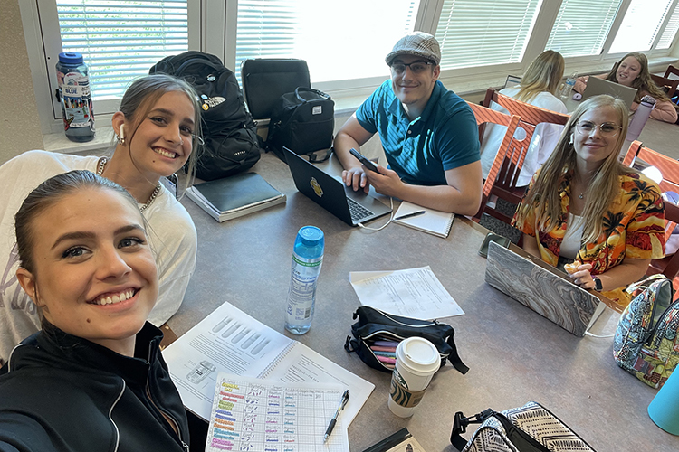 Four of the Fisher siblings, five family members who are all attending Middle Tennessee State University in Murfreesboro, Tennessee, at the same time, meet up to study together at the James E. Walker Library. Sitting, from left, are Calliope, Raquel, Joseph and Gabriela Fisher. (Submitted photo)