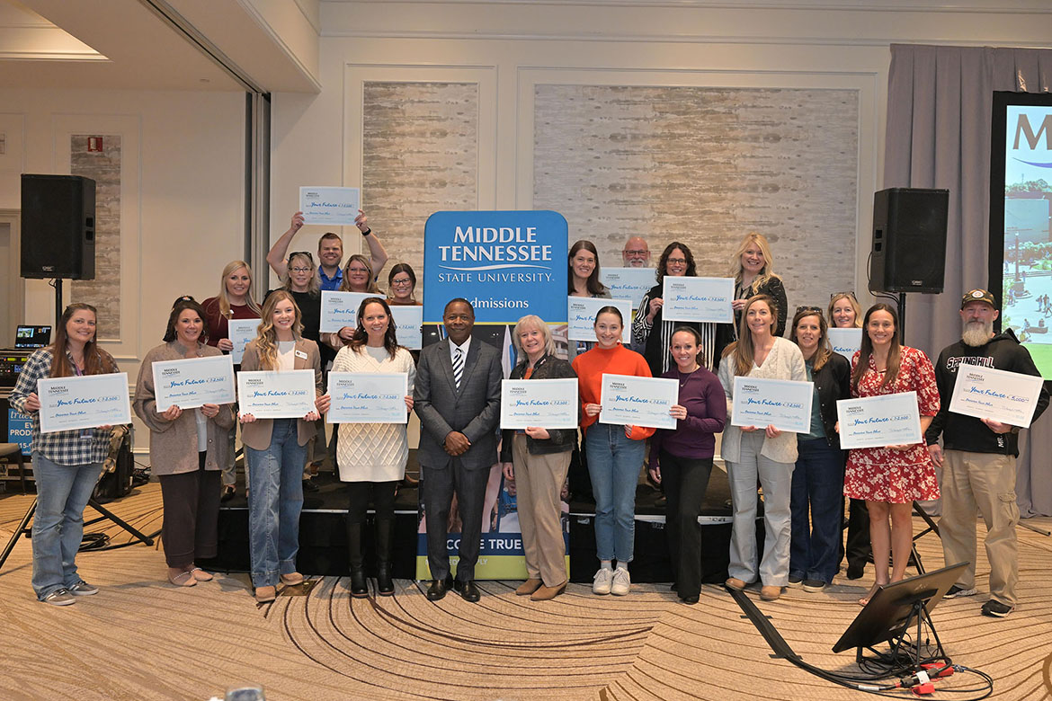 Middle Tennessee State University President Sidney A. McPhee, center left, stands with school counselors and community college advisors during the final True Blue Tour luncheon held Thursday, Nov. 13, at Franklin Marriott Cool Springs. A total of $65,000 in scholarships was given to each of the 24 institutions represented that day. (MTSU photo by James Cessna)