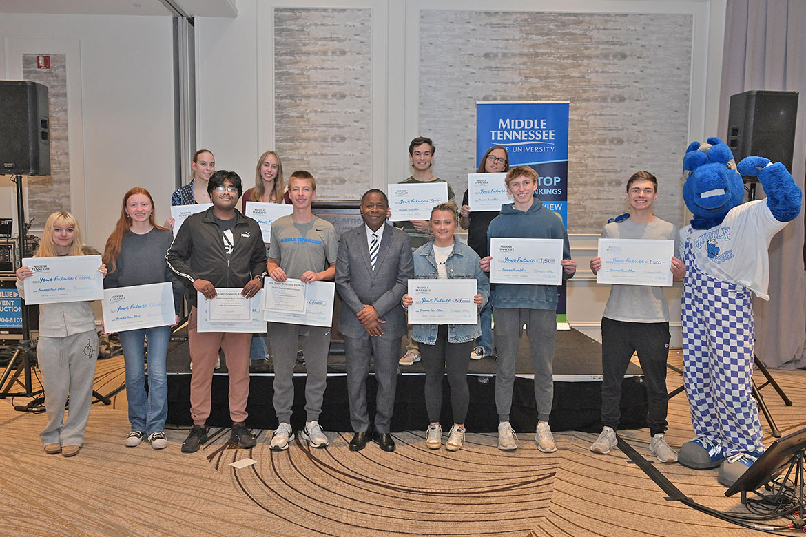 Middle Tennessee State University President Sidney A. McPhee, center, stands with scholarship winners at MTSU’s final True Blue Tour stop recruitment event held Thursday, Nov. 13, at Franklin Marriott Cool Springs. Twelve students won a total of $12,000 in scholarships. (MTSU photo by James Cessna)