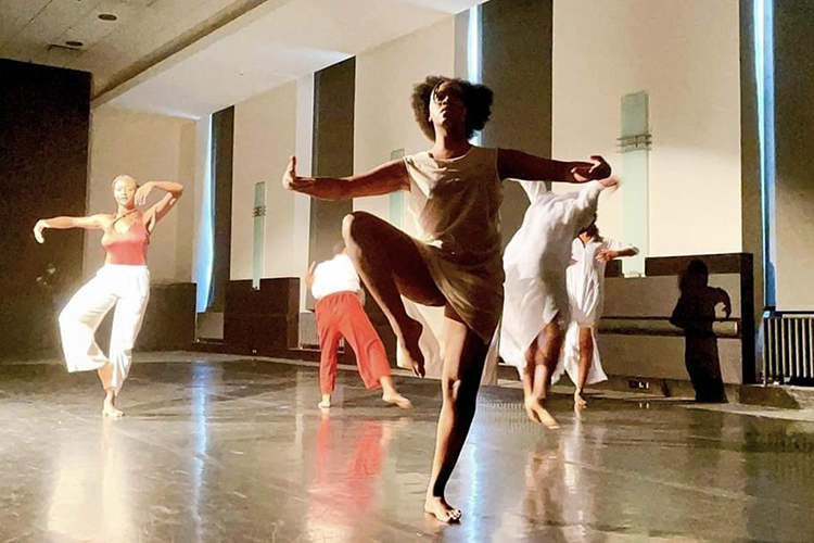 MTSU dance alumna Jordyn Hill, center, and professor Jade Treadwell, left, concentrate on their performance Saturday, July 24, in the auditorium at Nashville's Frist Art Museum while their fellow dancers strike poses behind them. The five-member troupe presented "Visceral Undercurrent," a dance routine Treadwell independently choreographed for the Frist that was inspired by its new exhibit, “Kara Walker: Cut to the Quick.” (photo courtesy of the Frist Art Museum)
