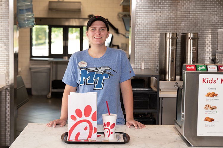 Middle Tennessee State University student and Murfreesboro Chick-fil-A employee Kaylin Garton, shown here inside one of the Murfreesboro locations in this 2022 file promotional photo, is taking advantage of a partnership between the restaurant and the university that provides tuition assistance to qualifying Chick-fil-A employees. (MTSU file photo by J. Intintoli)