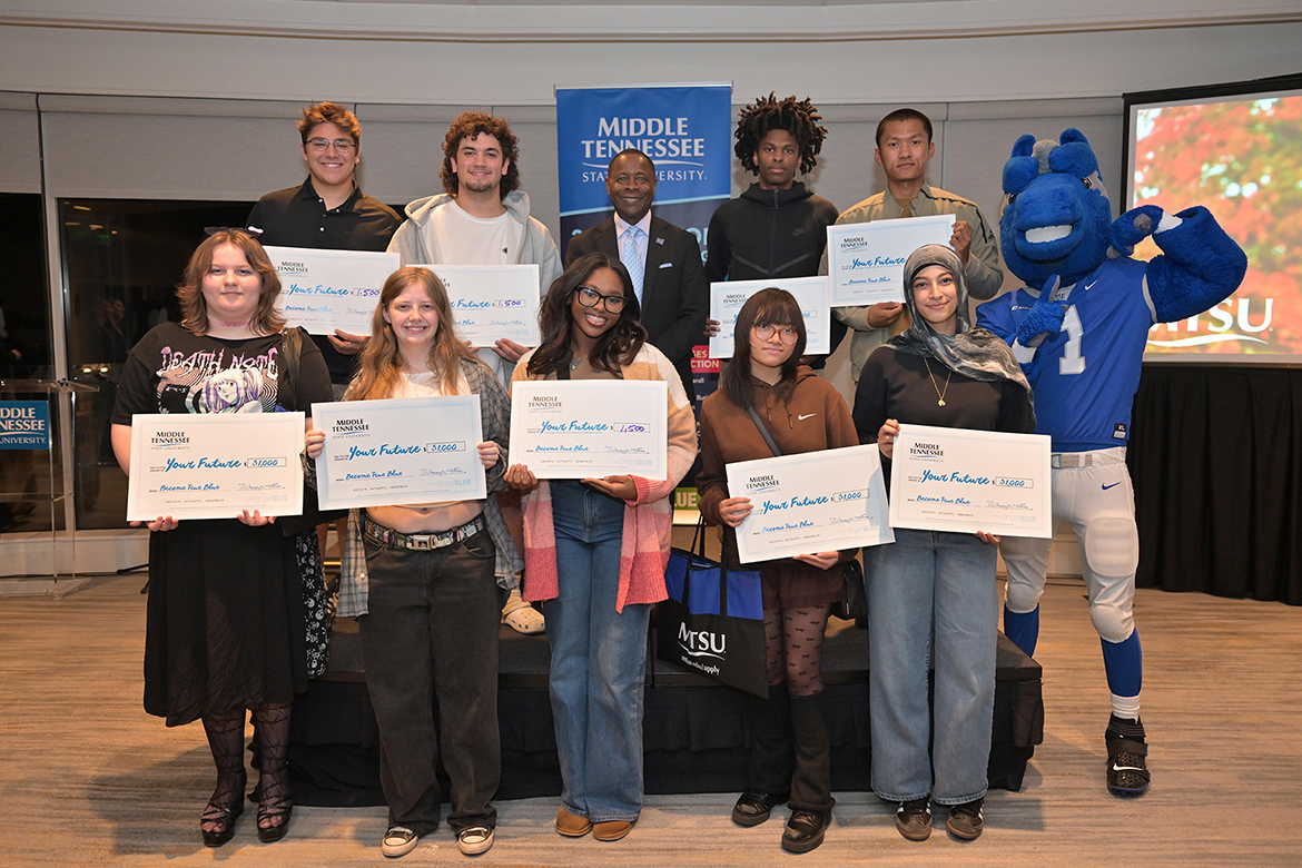 Middle Tennessee State University President Sidney A. McPhee, center, stands with students who were among the lucky winners in the scholarship drawings at the True Blue Tour recruitment stop for prospective students held Tuesday, Oct. 28, at Gaylord Springs Golf Links in Nashville, Tenn. Nine students won a total of $11,500 in scholarships. (MTSU photo by James Cessna)