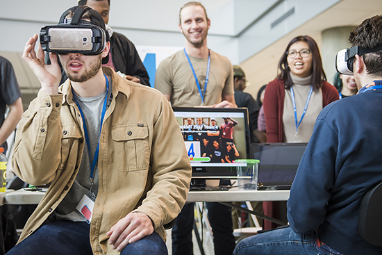 Attendees try out the first-place winner "VR-Maze.com," a virtual reality maze game for up to 100 players per map, during the Feb. 5 MTSU computer science Hack MT in the Science Building's Liz and Creighton Rhea Atrium. (MTSU photo by Kimi Conro)