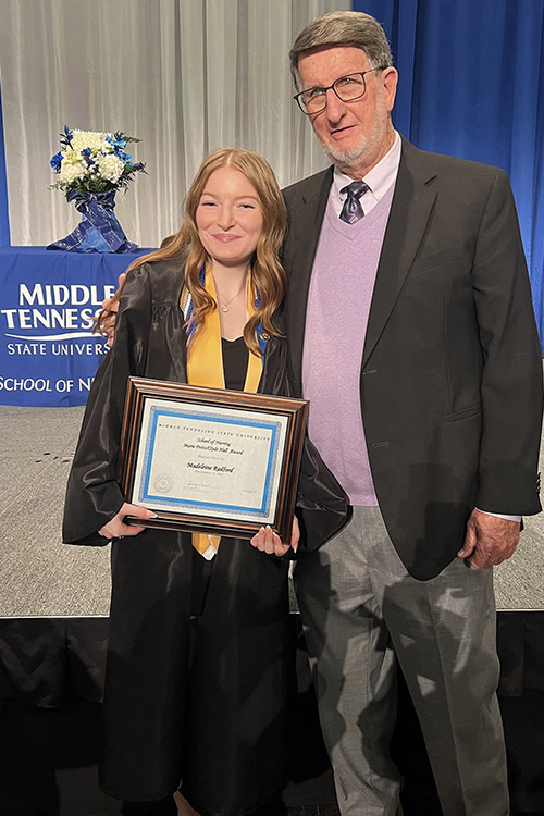 Middle Tennessee State University School of Nursing graduate Madeleine Radford, who was one of three students to receive the Marie Potts/Clyde Hall Personal Achievement Award, stands with nursing alumnus Clyde Hall, whose endowment provides the award's scholarship for students who exhibit need. The scholarship was awarded to Radford and two other students at the pinning ceremony for graduating School of Nursing students on Dec. 15, 2023. (Submitted photo)