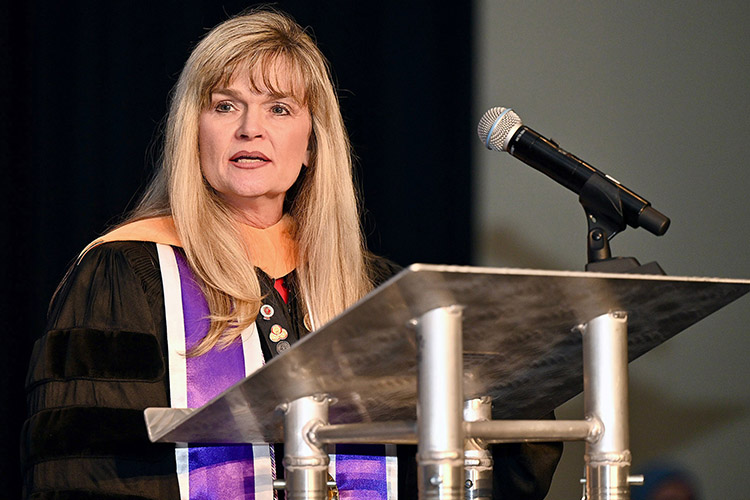 Jenny Sauls, director of the Middle Tennessee State University School of Nursing, addresses the crowd gathered at the pinning ceremony for graduating School of Nursing students Dec. 15, 2023. (MTSU photo by James Cessna)
