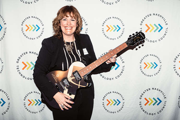 Middle Tennessee State University business intelligence and analytics professor Amy Harris holds the signature guitar-themed award from the Greater Nashville Technology Council Diversity as winner of the Inclusion Advocate of the Year Award at the 12th Annual NTC Awards ceremony was held in April from Stage Post Studios in Nashville, Tenn., as a hybrid in-person and virtual event. (Photo courtesy of Nathan Zucker)