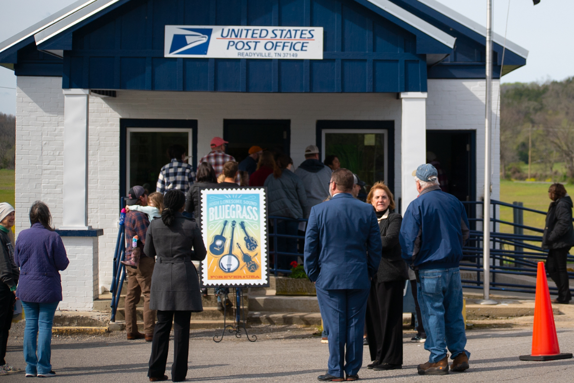 A large version of the High Lonesome Sound Bluegrass forever stamp designed by Middle Tennessee State University alumna Heather Moulder is on display outside the post office in Readyville, Tenn., as part of an unveiling ceremony in April. (Photo courtesy of Daxton Patrick)