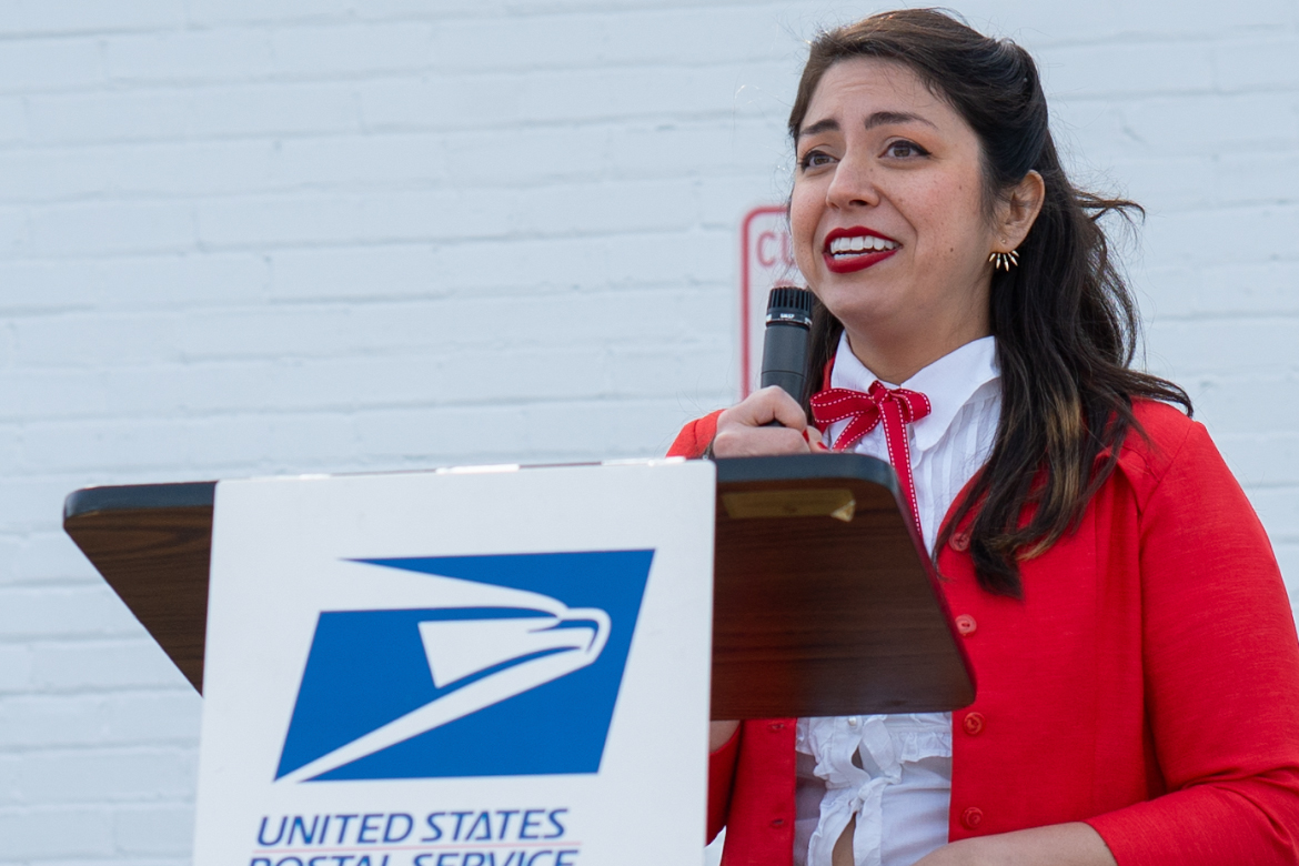 Middle Tennessee State University graphic design alumna Heather Moulder speaks at the unveiling of the new High Lonesome Sound Bluegrass forever stamp that she designed for the United States Postal Service at a ceremony in April at a post office in Readyville, Tenn.,  released by the United States Postal Service in April 2024. (Photo courtesy of Daxton Patrick)