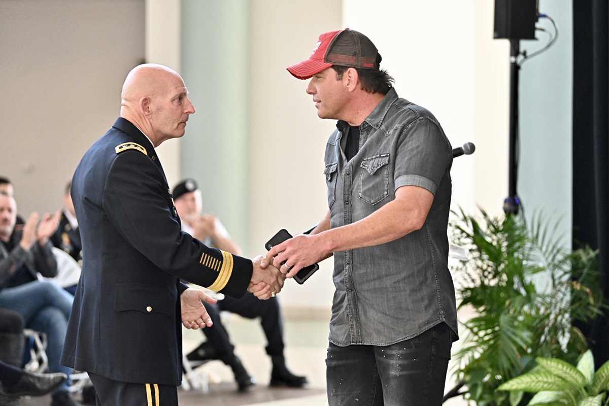 MTSU veterans adviser and retired Lt. Gen. Keith M. Huber, left, shakes hands with country music entertainer Rodney Atkins after both attended the Daniels Veterans Center’s 9/11 Remembrance ceremony in September 2019 in the Miller Education Center atrium. Atkins announced plans to organize the Songs for Service concert in Murphy Center this Sept. 11, but he, Huber and others are canceling it because of COVID-19 concerns. (MTSU file photo by J. Intintoli)