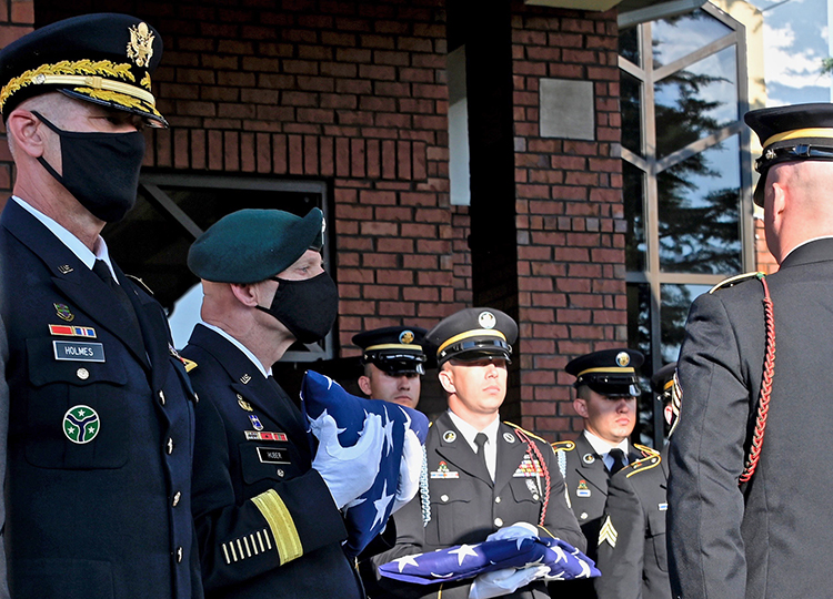 Retired Army Lt. Gen. Keith Huber, MTSU’s senior advisor for veterans and leadership initiatives, second from left, holds the folded American flag that had draped the coffin of country music icon Charlie Daniels. Huber would later present the flag to Daniels’ widow, Hazel, during a memorial service Tuesday in the couple’s hometown of Mt. Juliet, Tenn. Daniels, who died Monday at age 83, is patron of the university’s veterans center. At far left is Army Maj. Gen. Jeff Holmes, the state’s adjutant general. (MTSU photo by Andrew Oppmann)