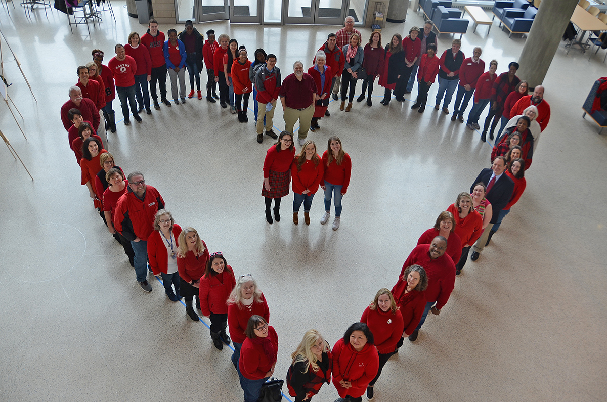 With nearly everyone wearing red on “Wear Red Day,” MTSU staff and students form a large human heart in the Science Building’s Liz and Creighton Rhea Atrium Feb. 7 as they learned about risks and symptoms of heart disease in women and men. This year’s honorees Trisha Murphy, left, Emily Hasty and Hannah Daigle stand in the center area. (MTSU photo by Randy Weiler)