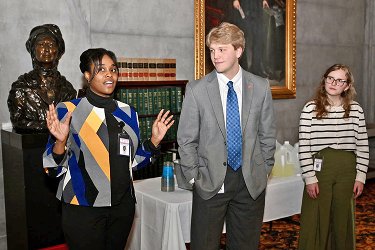 Tiffany Parker, left, a senior at Middle Tennessee State University in Murfreesboro, Tenn., talks about her participation in the 2025 Tennessee Legislative Intern Program in the office of state Rep. Mike Sparks, R-Smyrna, as fellow interns and MTSU alumni Tyler Martin, center, and Anna Collins listen inside the Tennessee Capitol in Nashville, Tenn. The three interns were spotlighted during a luncheon held Feb. 12 as part of MTSU’s annual Day on the Hill activities that included which celebrating the work of MTSU students who participate in the internship program. (MTSU photo by James Cessna)