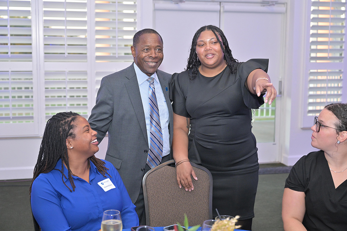 Middle Tennessee State University President Sidney A. McPhee, standing left, shares a lighthearted moment with alumna Courtney Martin, standing right, recipient of the Young Professional of the Year Award presented by the Jones College of Business during a special 2025 Leadership Awards ceremony held Oct. 14 at Stones River Country Club in Murfreesboro, Tenn. (MTSU photo by James Cessna)