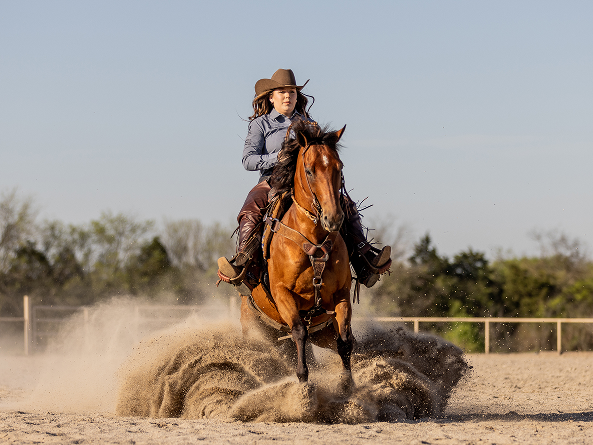 Middle Tennessee State University stock horse team member JoBeth Scarlett of New Market, Tenn., performs a sliding stop on Twentyeleventwister in competition. She and her horse were National All-Around Champions in the Non-Pro Division at the national competition in Sweetwater, Texas, and she scored 80 in the Limited Ranch Riding category at the event in Amarillo, Texas. (Photo by Cait Russell Photography)