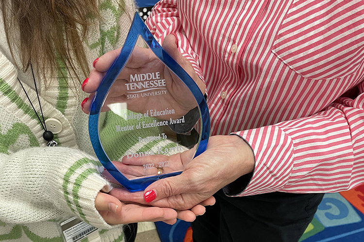 Donna Karrh, fourth-grade teacher at Northfield Elementary in Murfreesboro, Tenn., holds her Mentor Teacher of Excellence award with MTSU student Avery Lane, Karrh’s student teacher, on May 3, 2023. MTSU recently awarded a select group of local educators, like Karrh, for their work mentoring MTSU education students. (MTSU photo by Shannon Harmon)
