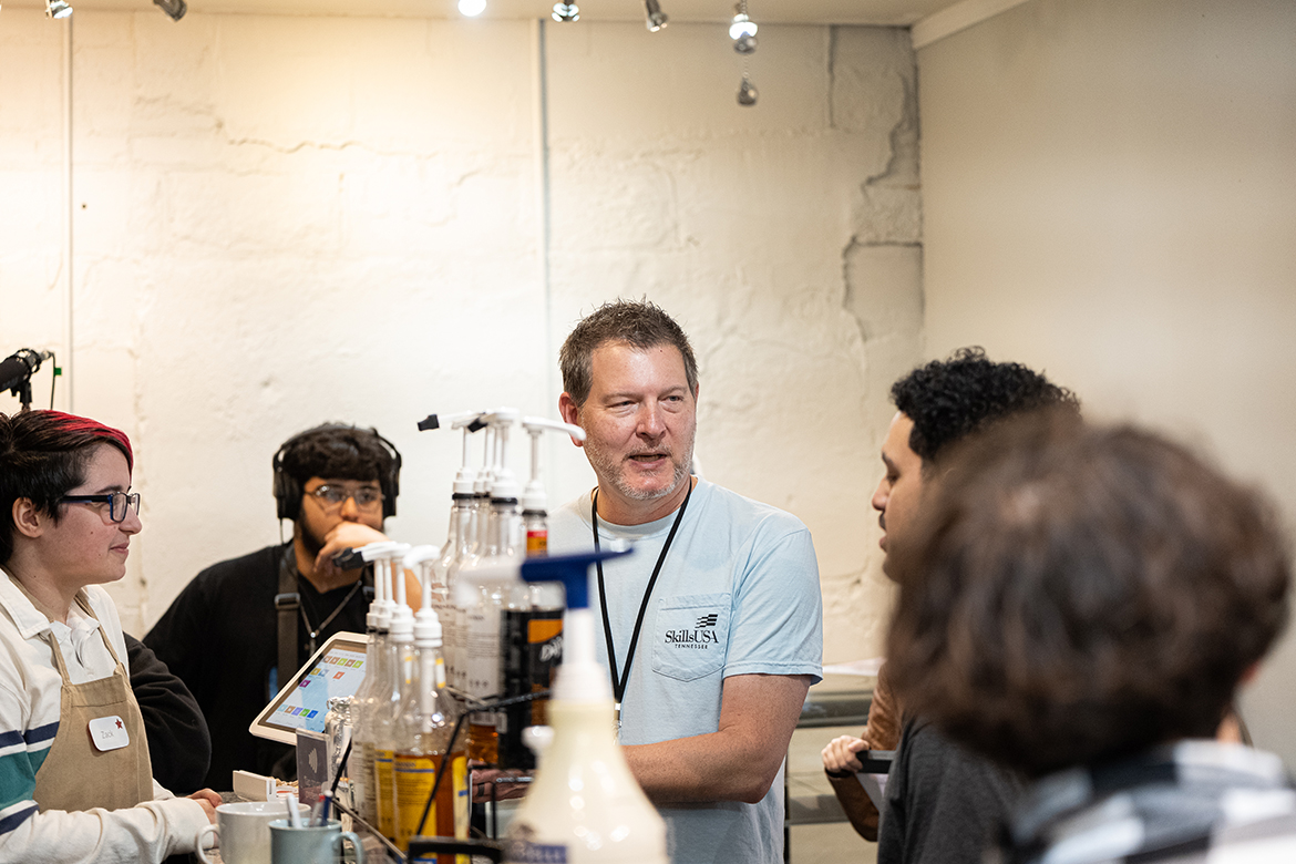Smyrna High School teacher Kyle Dietz, center, who joined the school in 2020 after a career in film, TV and video production, works with student actor Max Tomlin, left, student sound recordist Jesse Villanueva, back, and student director Alan Mata, right, on the set of the student-produced film, “The Strings Attached,” which will be aired later this month on Middle Tennessee State University’s True Blue TV. (Photo courtesy of Kyle Dietz)