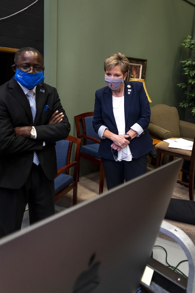 MTSU President Sidney A. McPhee, left, and Blackman High School Principal Leisa Justus watch the virtual Blackman Collegiate Academy Pinning Ceremony broadcast from inside LRC Studio A Thursday, Sept. 24. At the time, assistant principal and BCA Dean Justin Smith was introducing 75 seniors, who briefly shared about their capstone research projects. (MTSU photo by Kimi Conro)