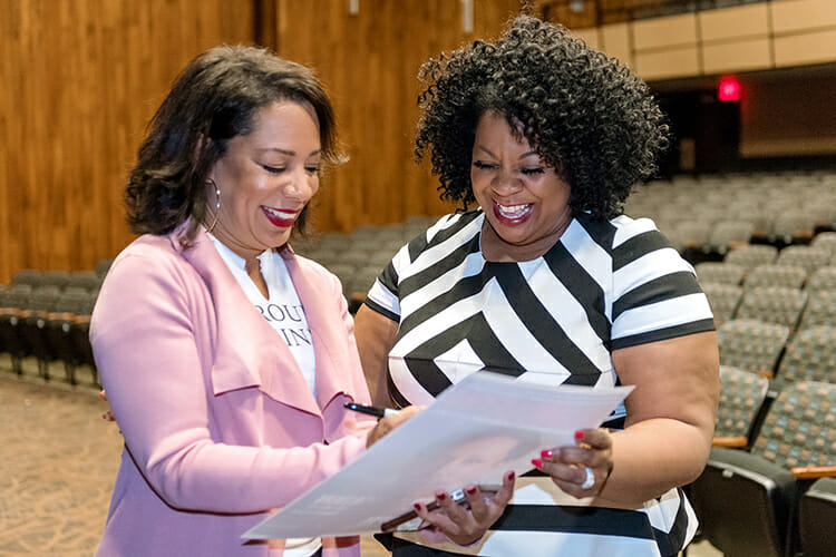 At right, Barbara Scales, director of MTSU’s June Anderson Center for Women and Nontraditional Students, smiles as she has her poster autographed by MTSU Women's History Month keynote speaker Selenis Leyva, one of the breakout stars of Netflix’s hit series “Orange Is The New Black.” Leyva shared her thoughts about self-image, diversity and inclusion April 9 inside MTSU’s Tucker Theatre. (MTSU photo by J. Intintoli)