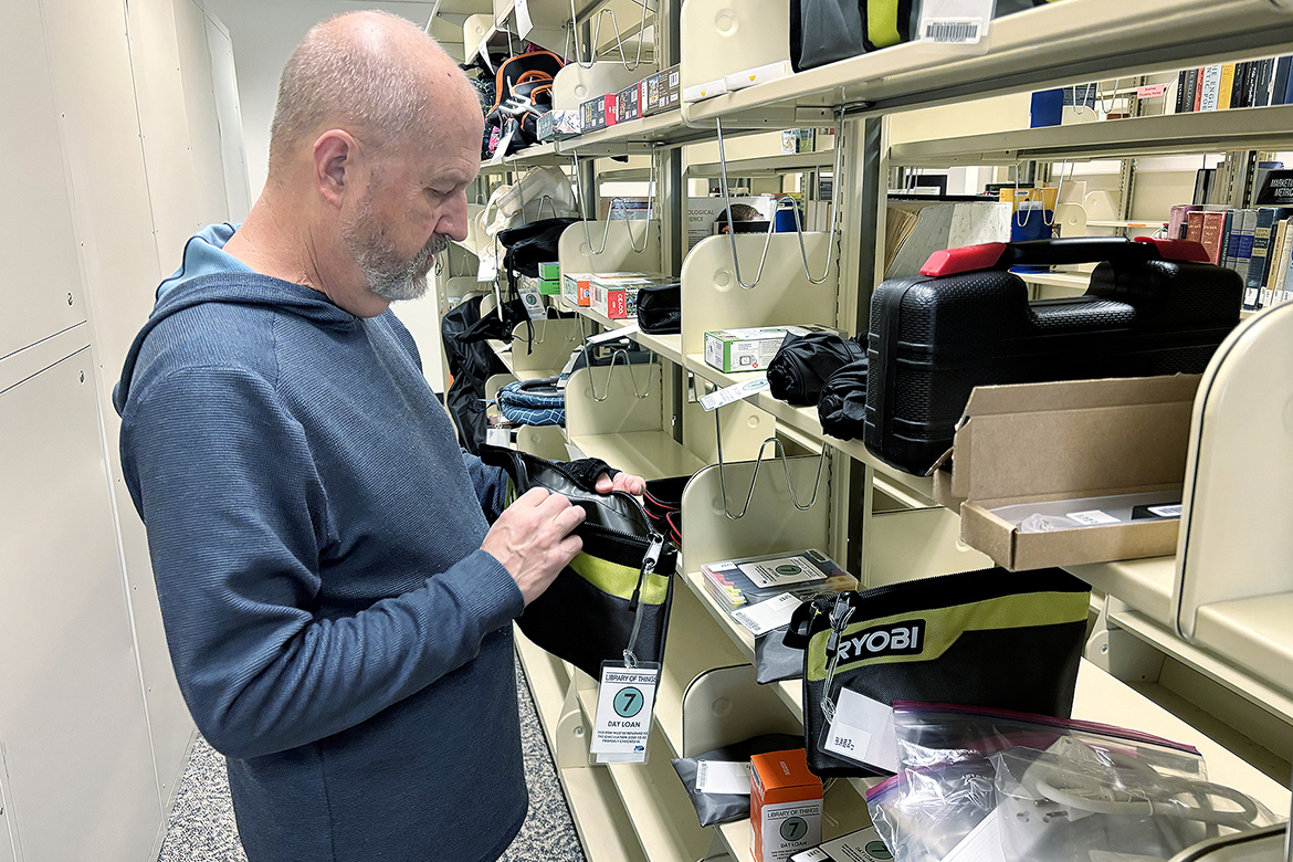 Paul Burt, library assistant at James E. Walker Library at Middle Tennessee State University in Murfreesboro, Tenn., sorts through items in the tool section of the Library of Things. Students can check out items for free from this section of the library, from umbrellas and power tools to iron boards and craft supplies. The free service is one of hundreds of projects funded through the Sustainable Campus Fee over the past 20 years. (MTSU photo by Nancy DeGennaro)